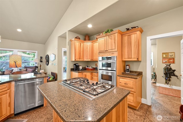 9135 Custer School Rd, Custer, WA 98240 - kitchen with stainless steel appliances, vaulted ceiling, light brown cabinets, a kitchen island, and dark stone counters