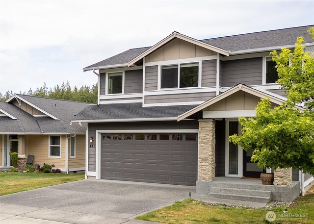 421 Lofgrin Rd, Sequim, WA 98382 - view of front facade featuring board and batten siding, concrete driveway, an attached garage, roof with shingles, and stone siding