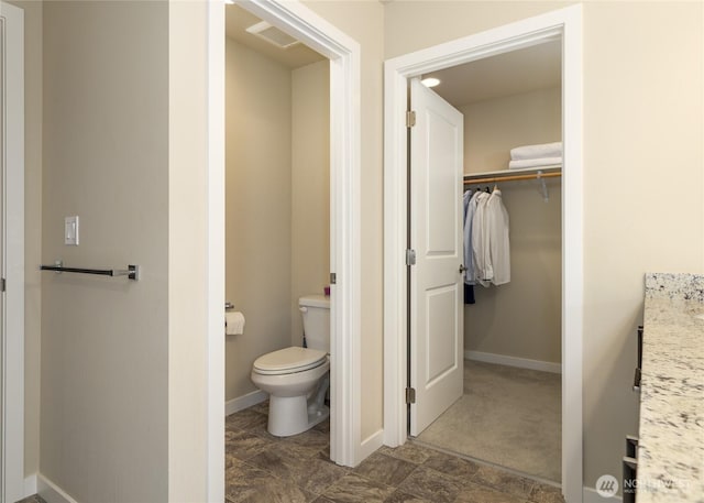 421 Lofgrin Rd, Sequim, WA 98382 - bathroom featuring toilet, a walk in closet, vanity, and baseboards