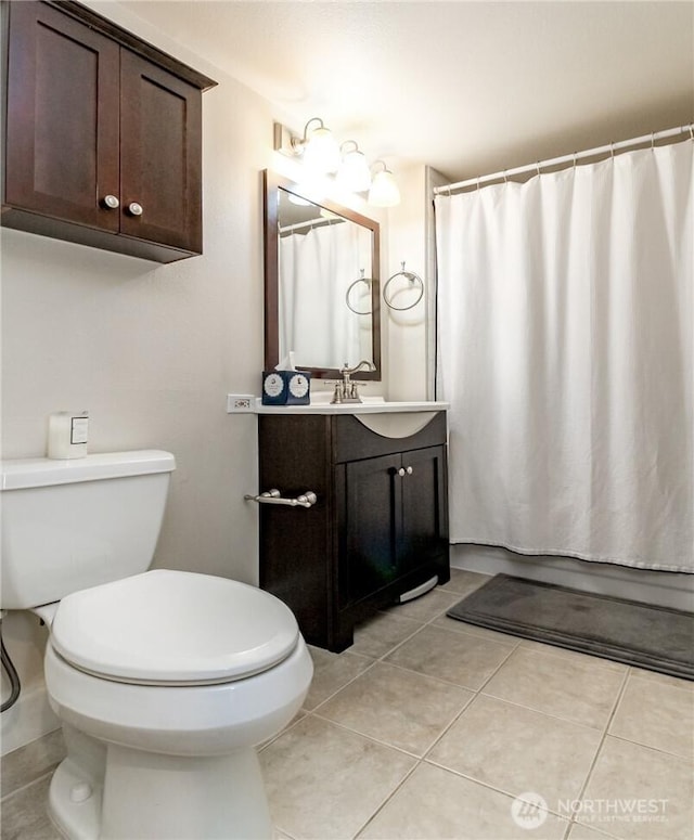 3028 Western Ave Unit 114, Seattle, WA 98121 - bathroom with vanity, toilet, and tile patterned floors