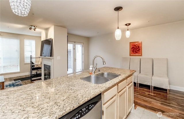 3028 Western Ave Unit 114, Seattle, WA 98121 - kitchen featuring a sink, plenty of natural light, pendant lighting, and light stone counters