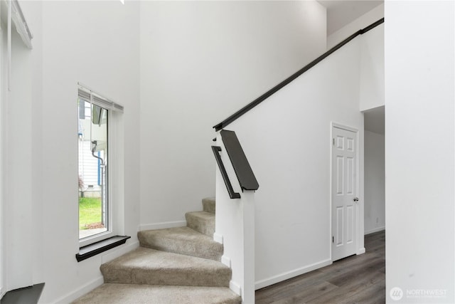 1258 NW Timber Shadow Ct, Silverdale, WA 98380 - staircase with a towering ceiling, healthy amount of natural light, baseboards, and wood finished floors