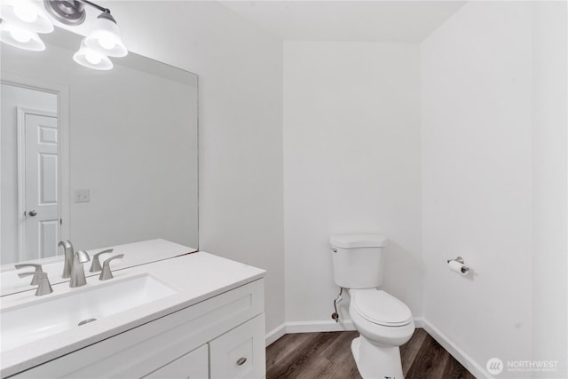1258 NW Timber Shadow Ct, Silverdale, WA 98380 - bathroom with toilet, wood finished floors, vanity, and baseboards