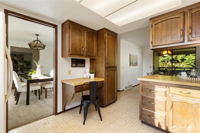 18801 86th Pl W, Edmonds, WA 98026 - kitchen featuring a chandelier, light flooring, light countertops, and freestanding refrigerator