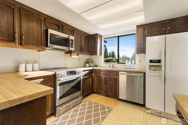 18801 86th Pl W, Edmonds, WA 98026 - kitchen with stainless steel appliances, light countertops, and dark brown cabinets