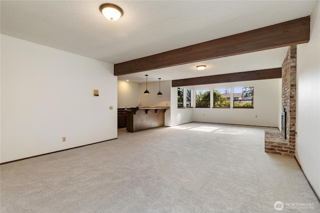 18801 86th Pl W, Edmonds, WA 98026 - unfurnished living room with light carpet, beam ceiling, a textured ceiling, and a fireplace