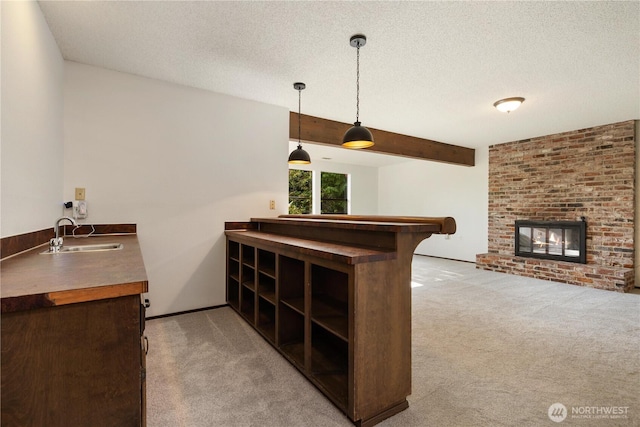 18801 86th Pl W, Edmonds, WA 98026 - bar with light carpet, a textured ceiling, pendant lighting, a fireplace, and beamed ceiling