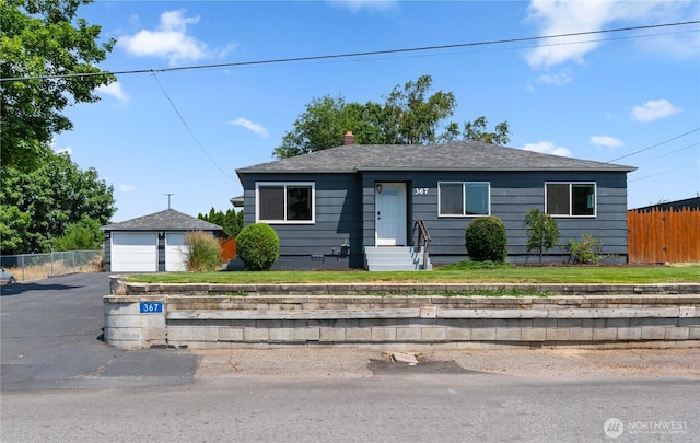 367 1st St SE, East Wenatchee, WA 98802 - bungalow-style house featuring a garage, entry steps, an outbuilding, a chimney, and roof with shingles