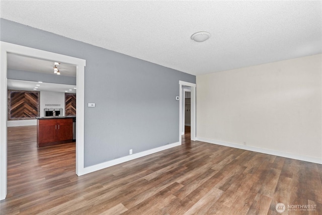 367 1st St SE, East Wenatchee, WA 98802 - unfurnished room with wood finished floors, baseboards, and a textured ceiling