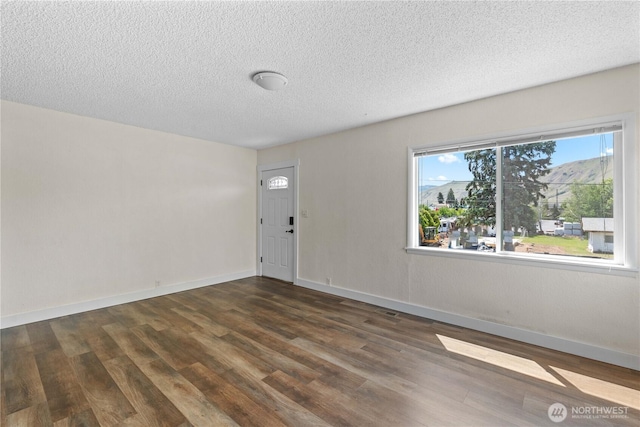 367 1st St SE, East Wenatchee, WA 98802 - entryway featuring dark wood-type flooring, a textured ceiling, and baseboards