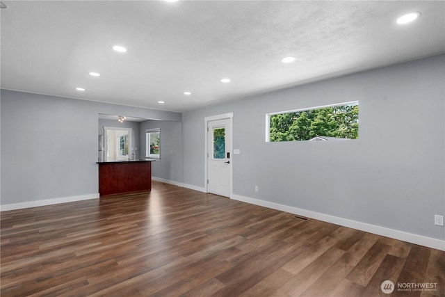 367 1st St SE, East Wenatchee, WA 98802 - unfurnished living room with recessed lighting, dark wood-style floors, and baseboards