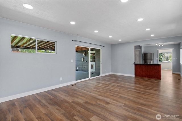 367 1st St SE, East Wenatchee, WA 98802 - unfurnished living room with recessed lighting, dark wood-style floors, and baseboards