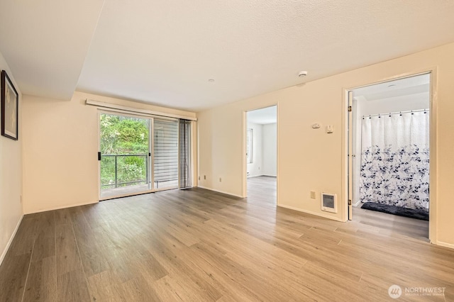 3022 SW Bradford St Unit 205, Seattle, WA 98126 - spare room with light wood finished floors and baseboards