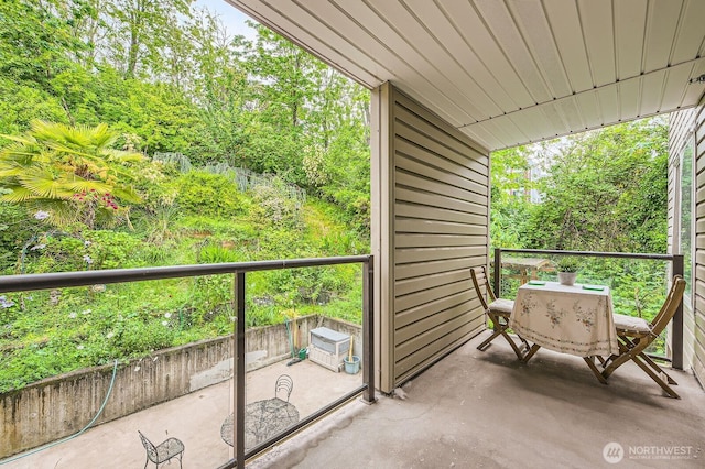 3022 SW Bradford St Unit 205, Seattle, WA 98126 - balcony featuring view of wooded area