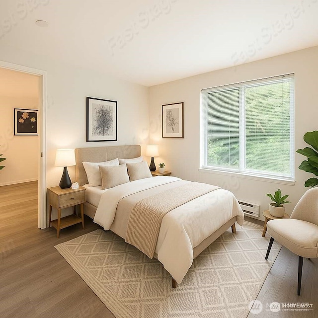 3022 SW Bradford St Unit 205, Seattle, WA 98126 - bedroom featuring light wood-type flooring and baseboard heating