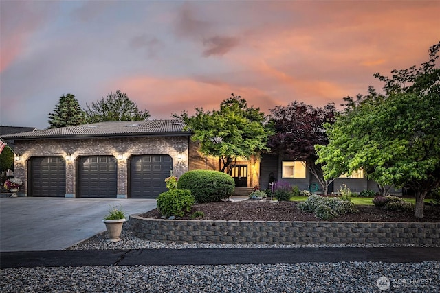 628 Meadows Dr, Wenatchee, WA 98801 - view of front facade with concrete driveway, an attached garage, and brick siding