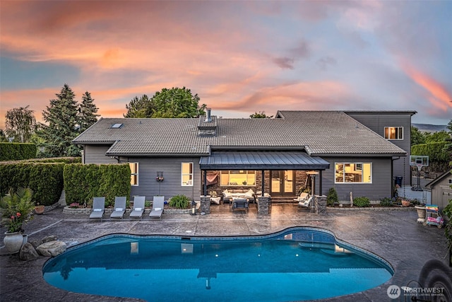 628 Meadows Dr, Wenatchee, WA 98801 - pool at dusk with a patio area and an outdoor living space