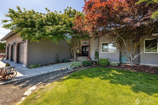 628 Meadows Dr, Wenatchee, WA 98801 - view of property hidden behind natural elements with a front lawn, concrete driveway, and an attached garage