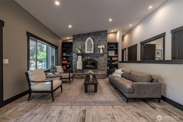 628 Meadows Dr, Wenatchee, WA 98801 - living room with wood finished floors, built in features, baseboards, vaulted ceiling, and a fireplace