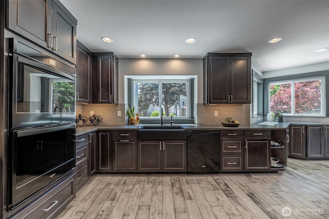 628 Meadows Dr, Wenatchee, WA 98801 - kitchen featuring black dishwasher, double oven, a sink, light wood-style flooring, and dark brown cabinetry