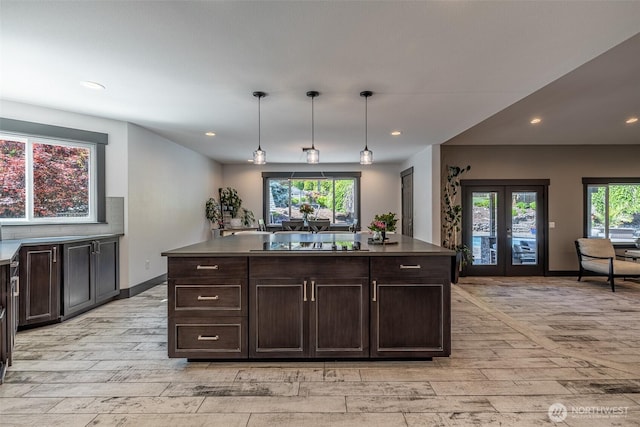628 Meadows Dr, Wenatchee, WA 98801 - kitchen with light wood finished floors, black electric cooktop, french doors, dark brown cabinetry, and recessed lighting