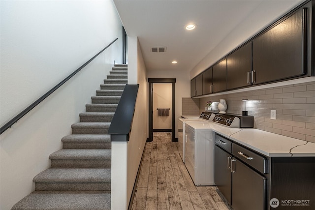628 Meadows Dr, Wenatchee, WA 98801 - kitchen featuring light countertops, light wood finished floors, tasteful backsplash, washer and dryer, and recessed lighting