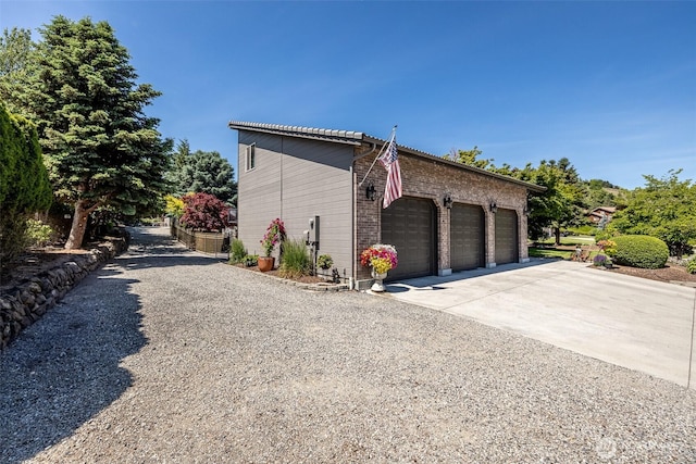 628 Meadows Dr, Wenatchee, WA 98801 - view of side of home featuring concrete driveway and an attached garage