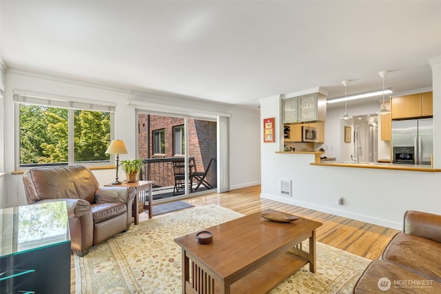 732 11th Ave E Unit 202, Seattle, WA 98102 - living area with crown molding, light wood-style flooring, and baseboards