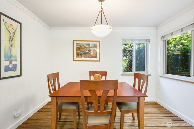 732 11th Ave E Unit 202, Seattle, WA 98102 - dining room with wood finished floors, ornamental molding, and baseboards