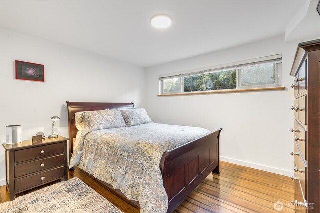 732 11th Ave E Unit 202, Seattle, WA 98102 - bedroom featuring baseboards and wood finished floors