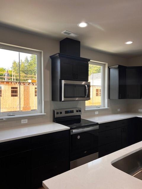 12092 126th Avenue Ct E Unit 70, Puyallup, WA 98374 - kitchen with appliances with stainless steel finishes, dark cabinets, light countertops, and recessed lighting