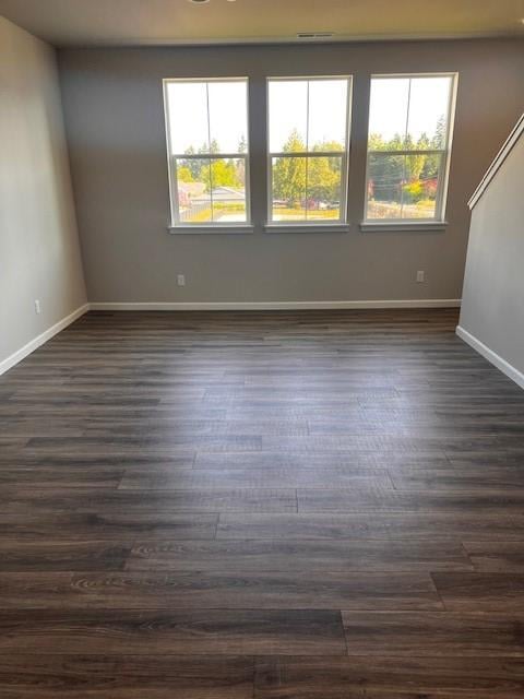 12092 126th Avenue Ct E Unit 70, Puyallup, WA 98374 - empty room with healthy amount of natural light, dark wood finished floors, and baseboards
