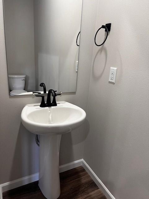 12092 126th Avenue Ct E Unit 70, Puyallup, WA 98374 - bathroom with a sink, wood finished floors, and baseboards