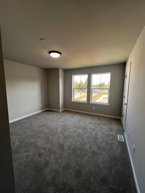 12092 126th Avenue Ct E Unit 70, Puyallup, WA 98374 - empty room featuring dark carpet and baseboards