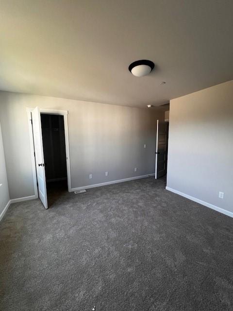 12092 126th Avenue Ct E Unit 70, Puyallup, WA 98374 - spare room featuring dark carpet and baseboards