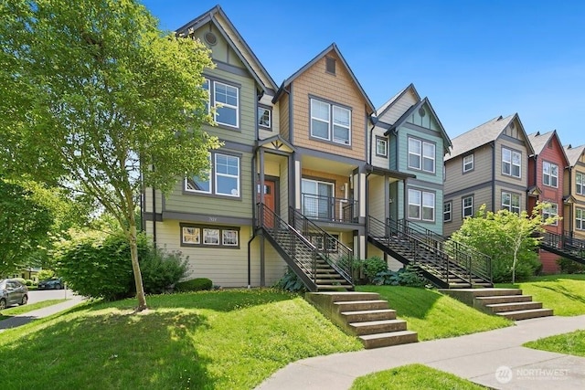 7121 Shinkle Pl SW, Seattle, WA 98106 - view of property with stairs, a front yard, a residential view, and covered porch