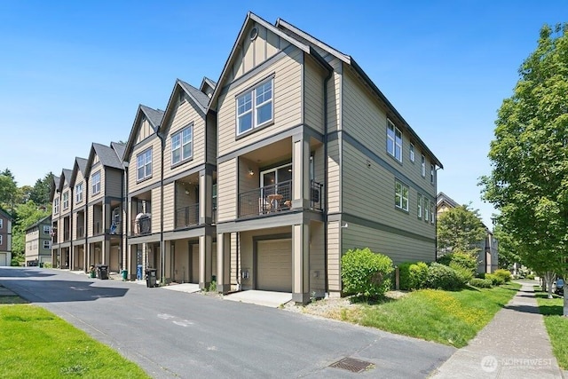 7121 Shinkle Pl SW, Seattle, WA 98106 - view of side of home featuring board and batten siding, a balcony, and a garage