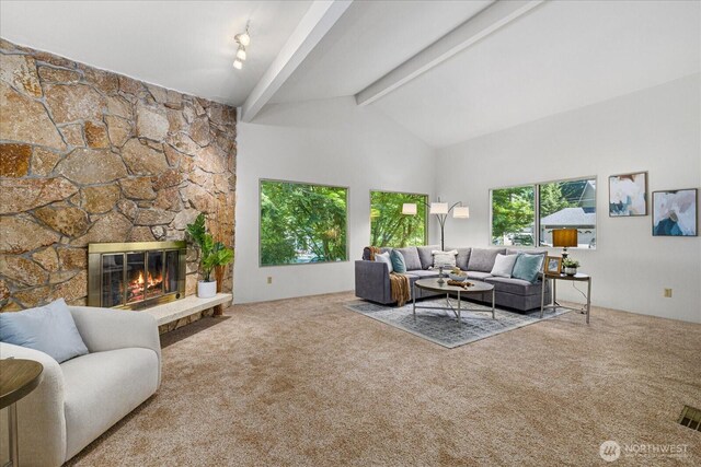 7223 NE 160th St, Kenmore, WA 98028 - living area featuring carpet, beamed ceiling, a stone fireplace, and high vaulted ceiling
