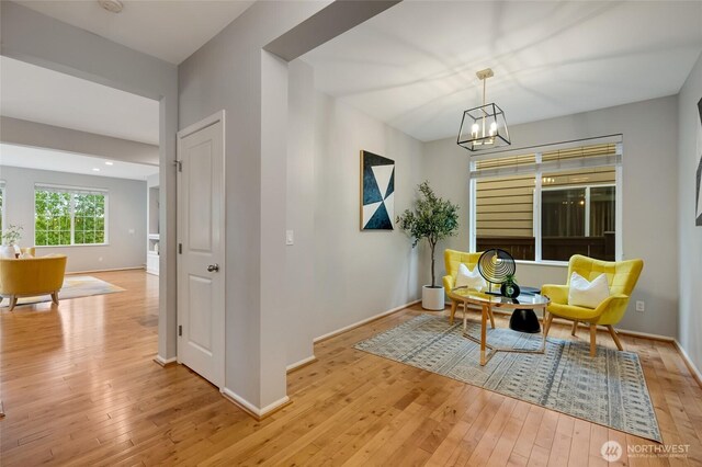 18307 38th Dr SE, Bothell, WA 98012 - living area featuring light wood-style floors, a chandelier, and baseboards