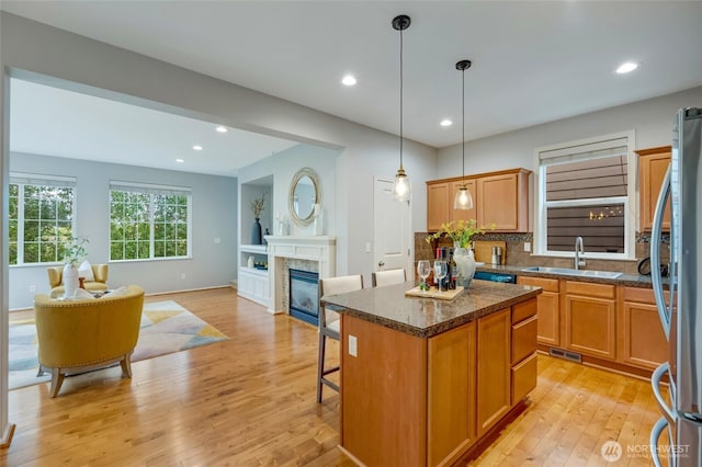 18307 38th Dr SE, Bothell, WA 98012 - kitchen featuring a sink, light wood finished floors, a kitchen island, freestanding refrigerator, and open floor plan