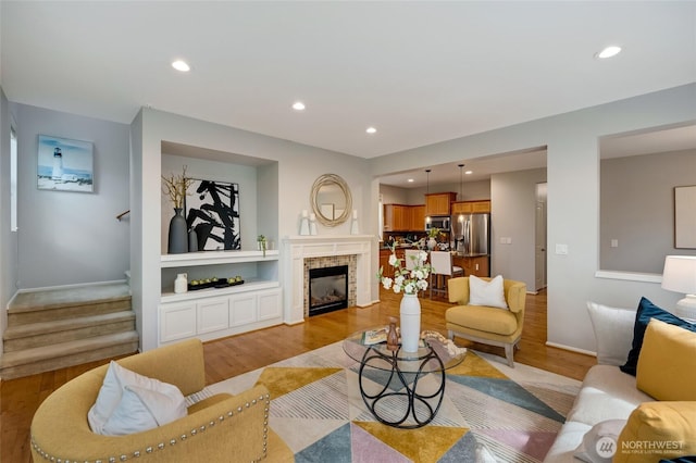 18307 38th Dr SE, Bothell, WA 98012 - living area featuring light wood-style flooring, stairway, recessed lighting, baseboards, and a tiled fireplace