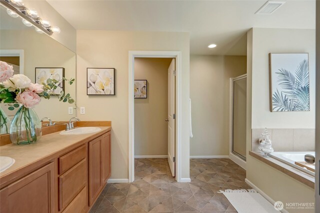 18307 38th Dr SE, Bothell, WA 98012 - bathroom featuring a shower stall, a bath, double vanity, recessed lighting, and baseboards