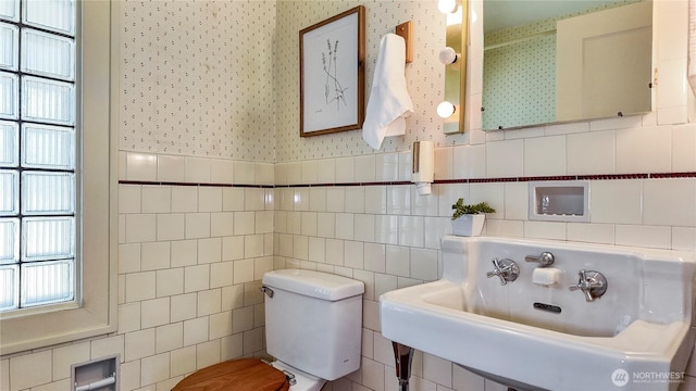 2502 Thurston Ave NE, Olympia, WA 98506 - bathroom featuring wallpapered walls, a sink, tile walls, and toilet