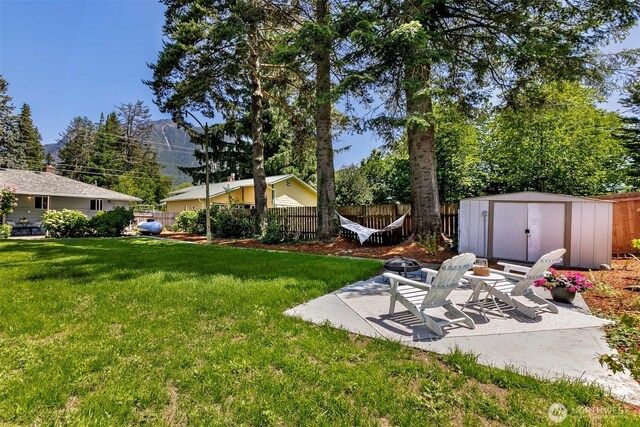 331 E 2nd St, North Bend, WA 98045 - fenced backyard featuring a patio and a storage shed