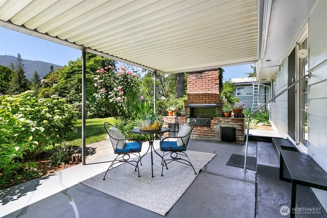 331 E 2nd St, North Bend, WA 98045 - view of patio / terrace with an outdoor brick fireplace and a mountain view