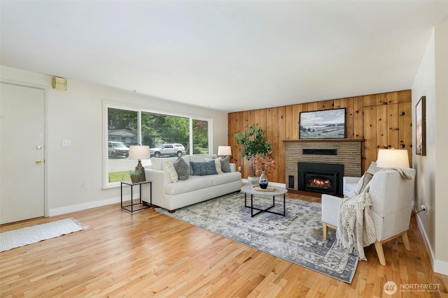 331 E 2nd St, North Bend, WA 98045 - living room with a fireplace, wooden walls, and wood finished floors