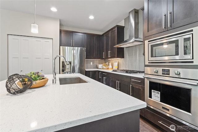 4008 223rd Pl SE, Bothell, WA 98021 - kitchen featuring wall chimney exhaust hood, stainless steel appliances, dark brown cabinets, light stone counters, and backsplash