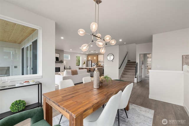 4576 22nd Ave SW, Seattle, WA 98106 - dining room featuring dark wood-style flooring, stairway, a chandelier, and recessed lighting