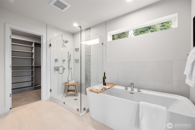 4576 22nd Ave SW, Seattle, WA 98106 - full bath featuring a freestanding bath, a shower stall, a walk in closet, and recessed lighting