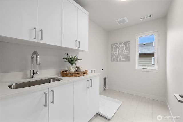 4576 22nd Ave SW, Seattle, WA 98106 - laundry room with hookup for an electric dryer, cabinet space, and hookup for a washing machine